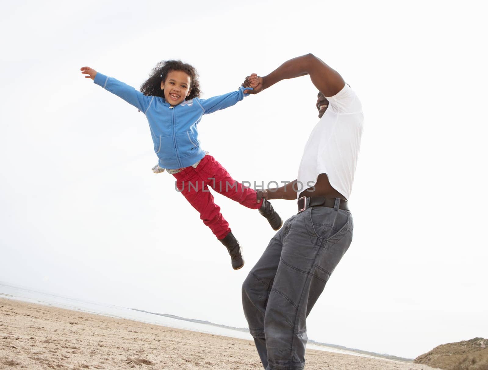 Young Family Relaxing On Beach Camping Holiday