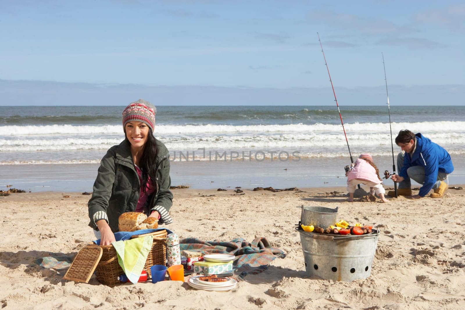 Family Having Picnic On Winter Beach