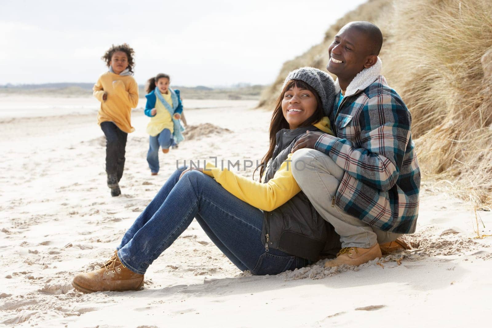 Family Having Fun On Winter Beach