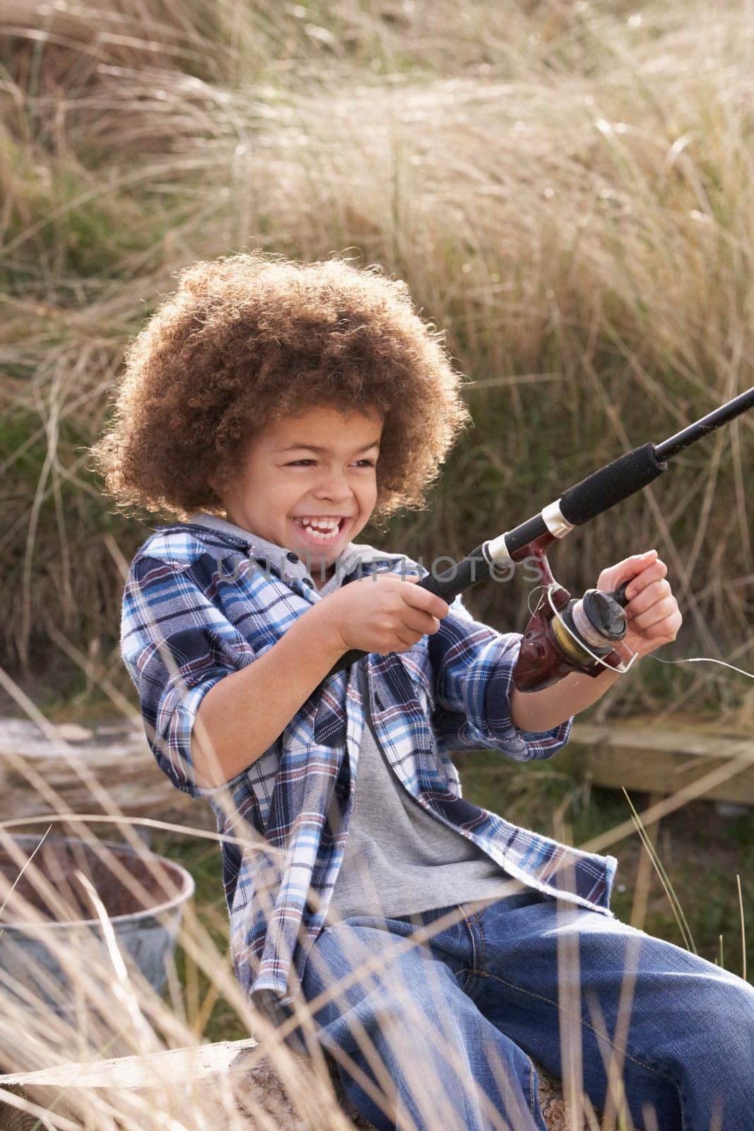 Young Boy Fishing At Seaside