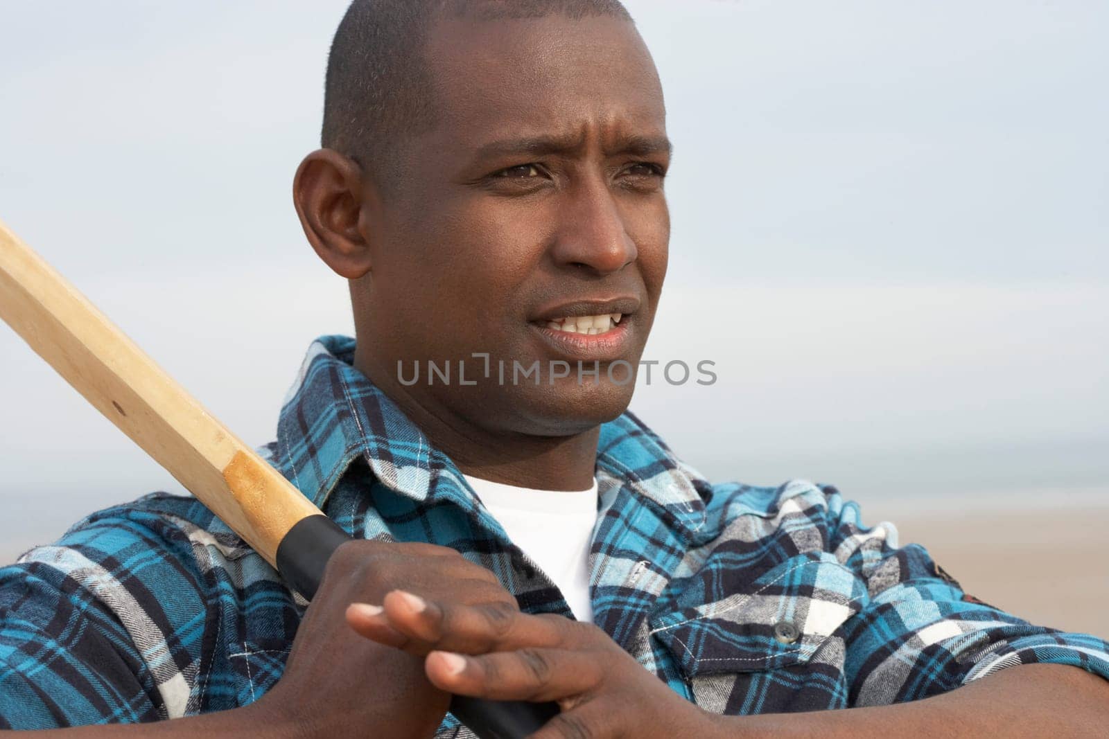 Young Man Playing Cricket On Autumn Beach Holiday