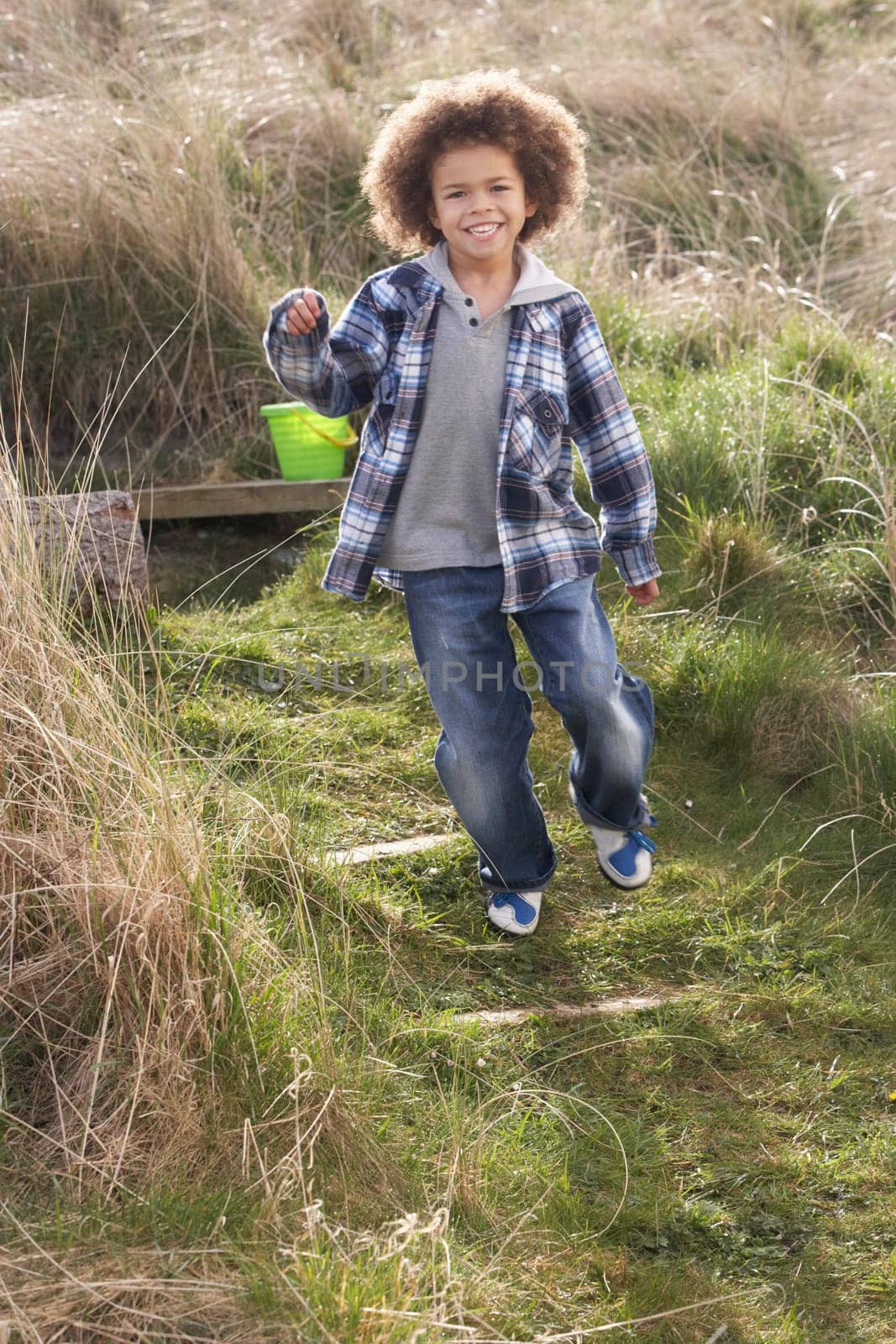 Young Boy Carrying Fishing Net At Seaside