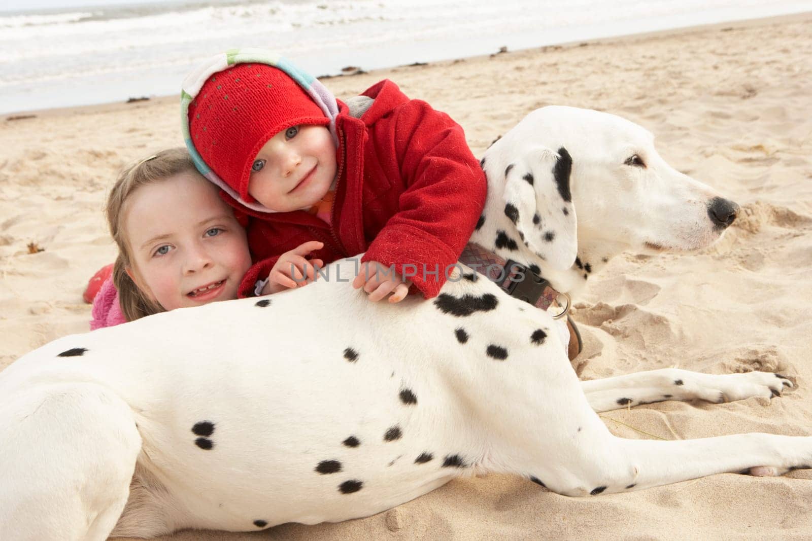 Two Girls On Beach With Pet Dog