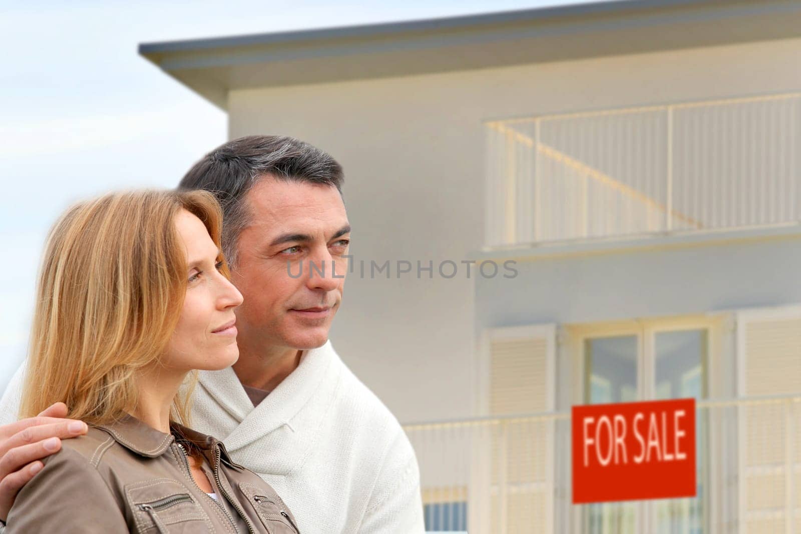Couple in front of house for sale