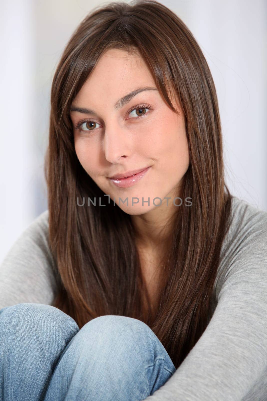 Beautiful woman sitting on sofa at home
