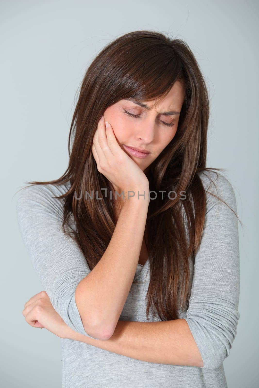Closeup of young woman having a toothache