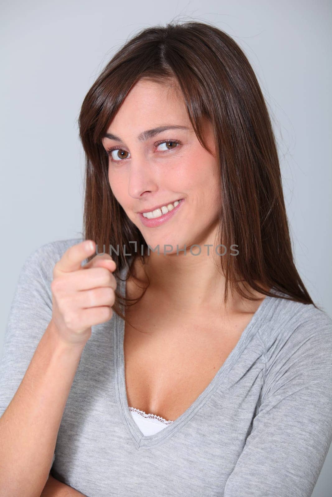 Young woman pointing at with finger