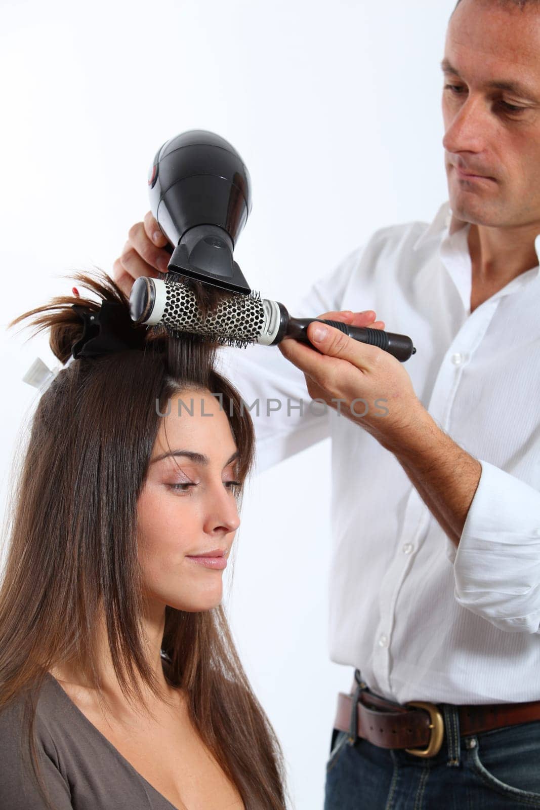Hairdresser drying woman's hair