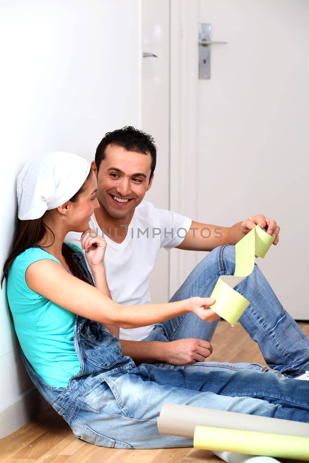 Young couple choosing color of wallpaper