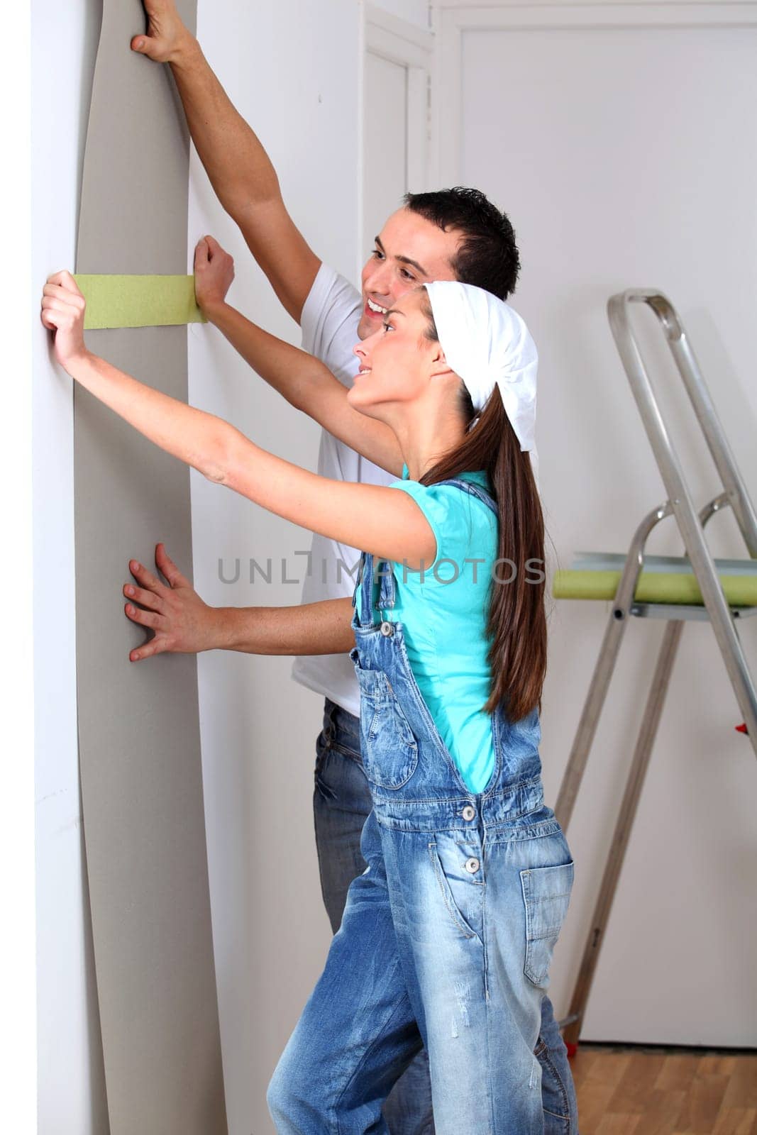 Young couple choosing color of wallpaper