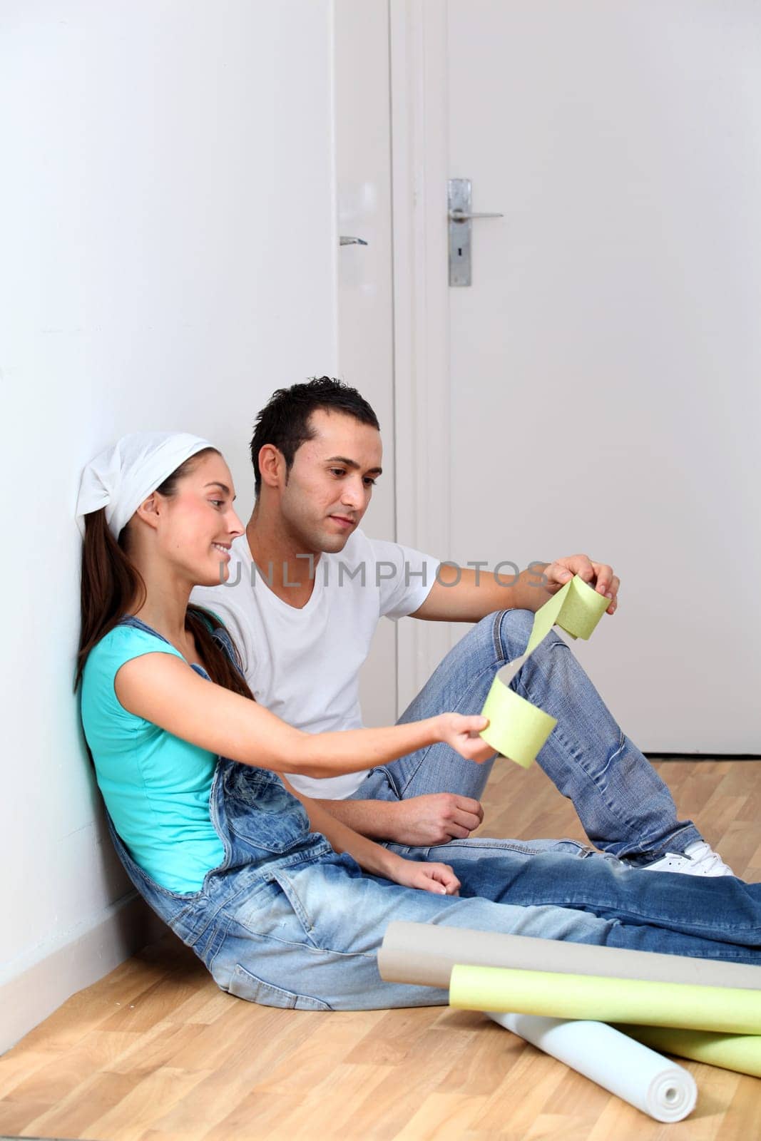 Young couple choosing color of wallpaper