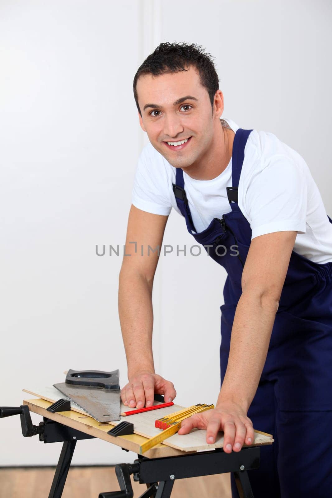 Young man working wood on workbench