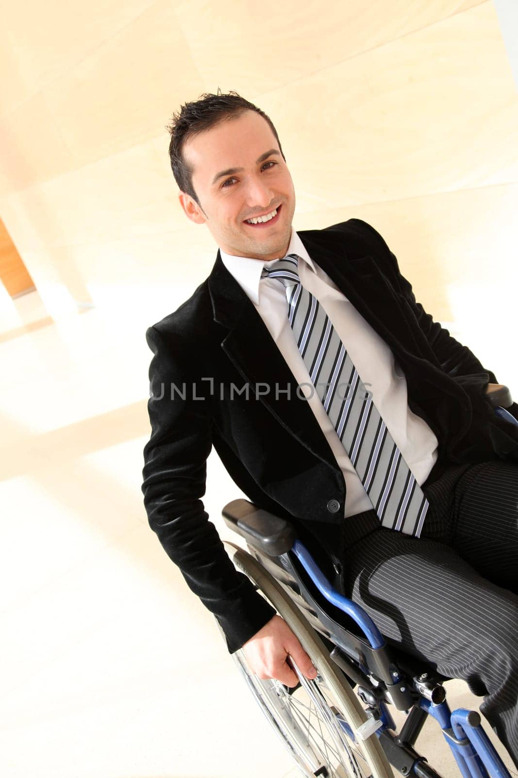 Businessman in wheelchair going to attend congress meeting