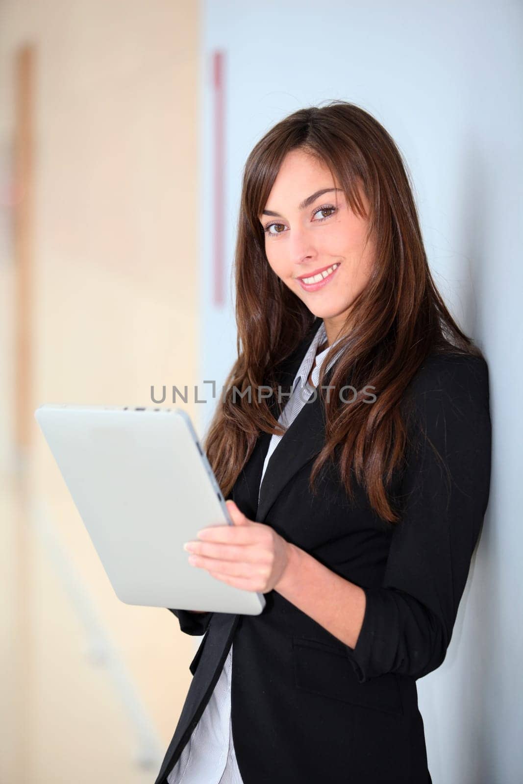 Businesswoman standing in hall with electronic pad