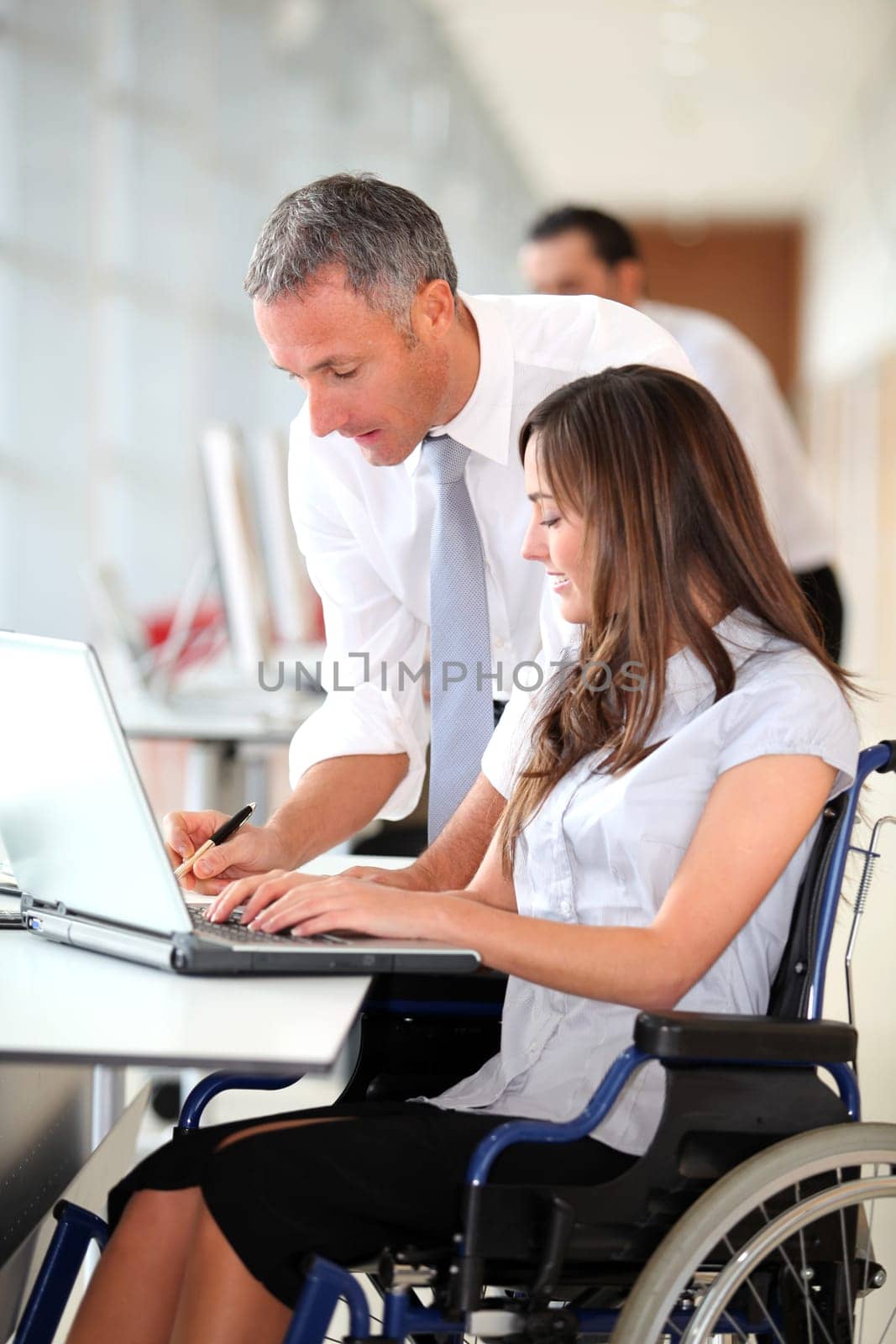 Manager and office worker in wheelchair