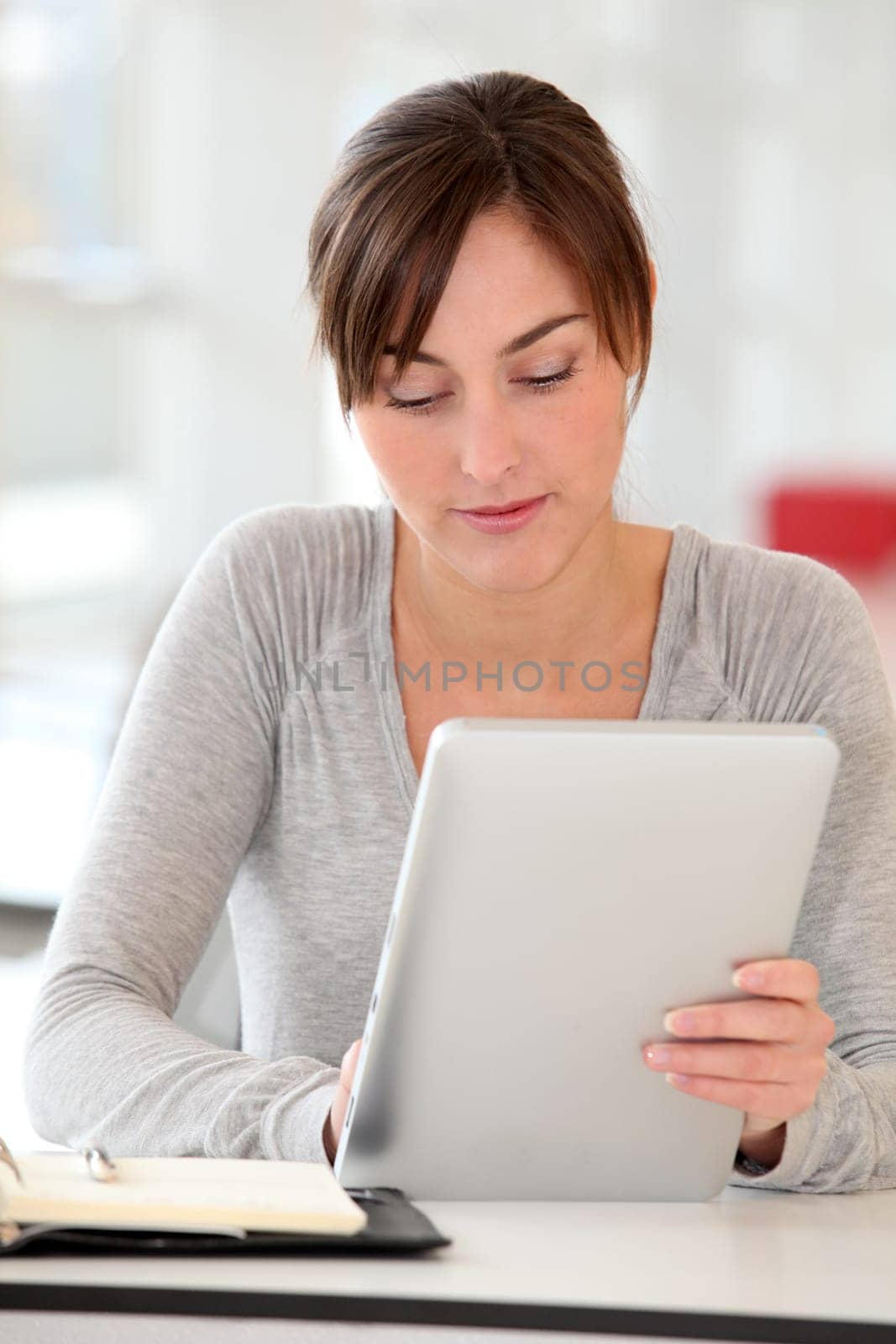 Beautiful businesswoman with electronic pad in the office