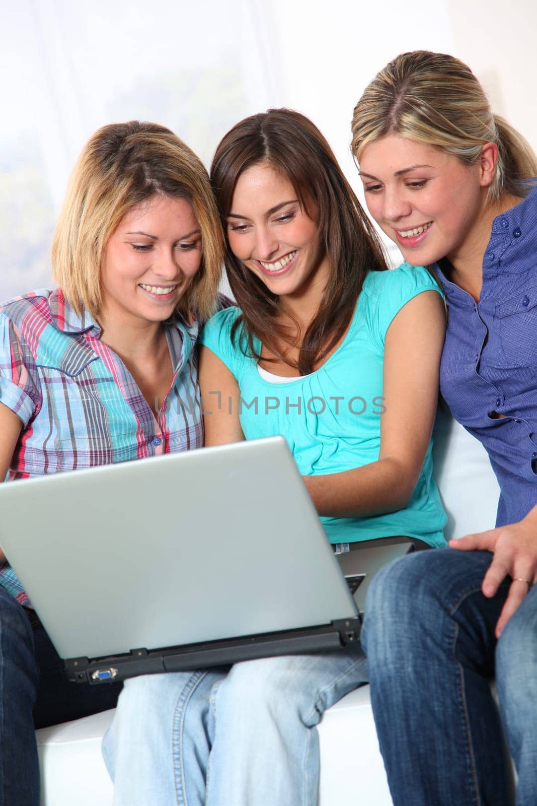 Group of happy girls surfing on internet