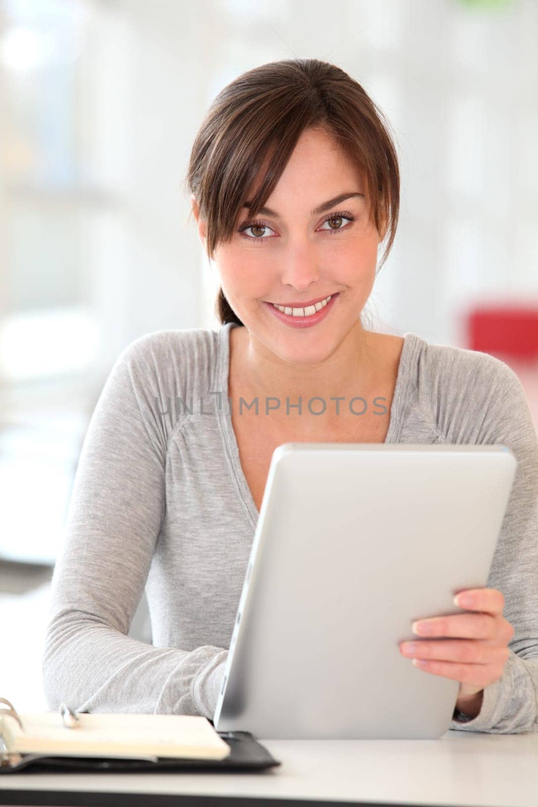 Beautiful businesswoman with electronic pad in the office