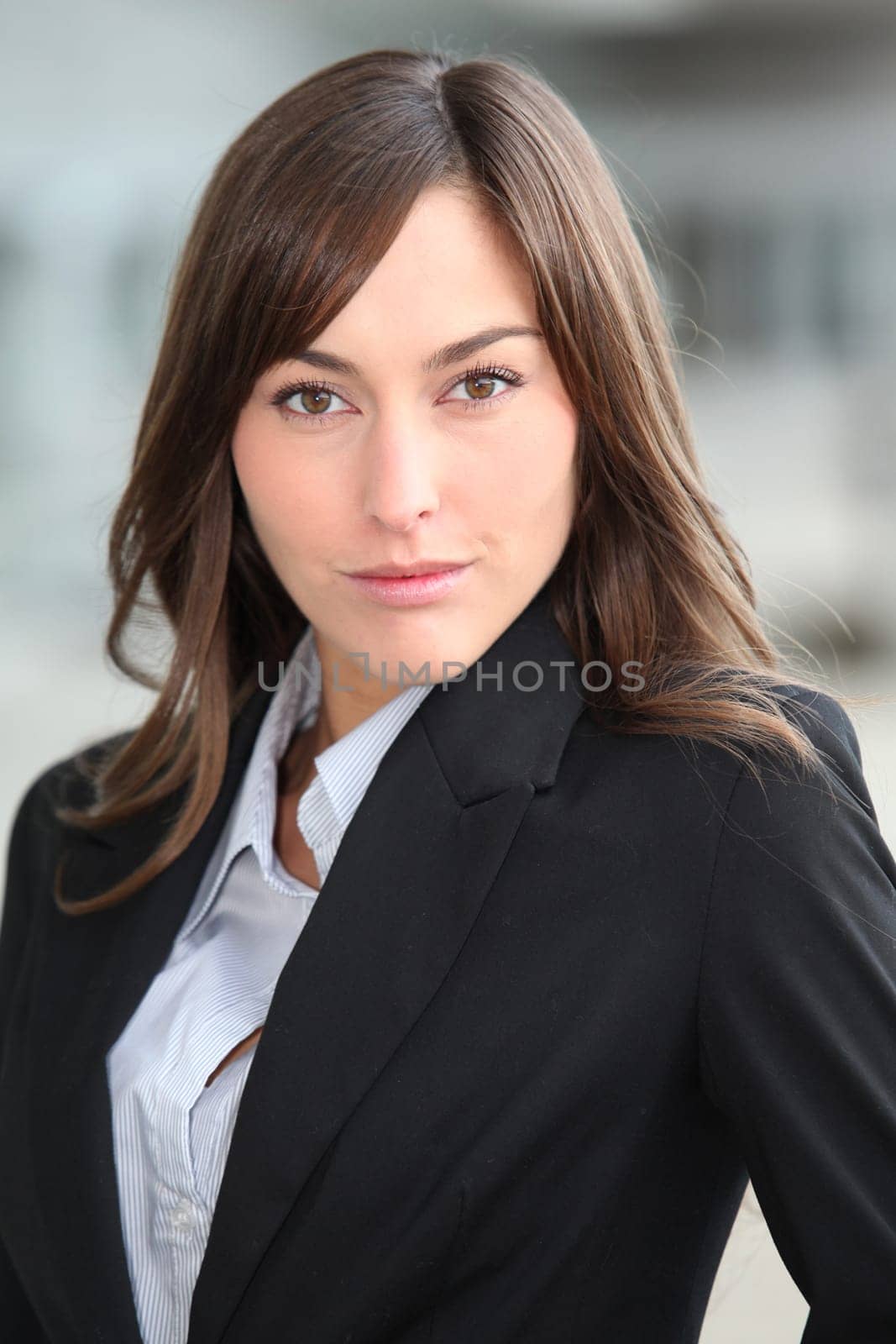 Closeup of beautiful businesswoman standing outside the office