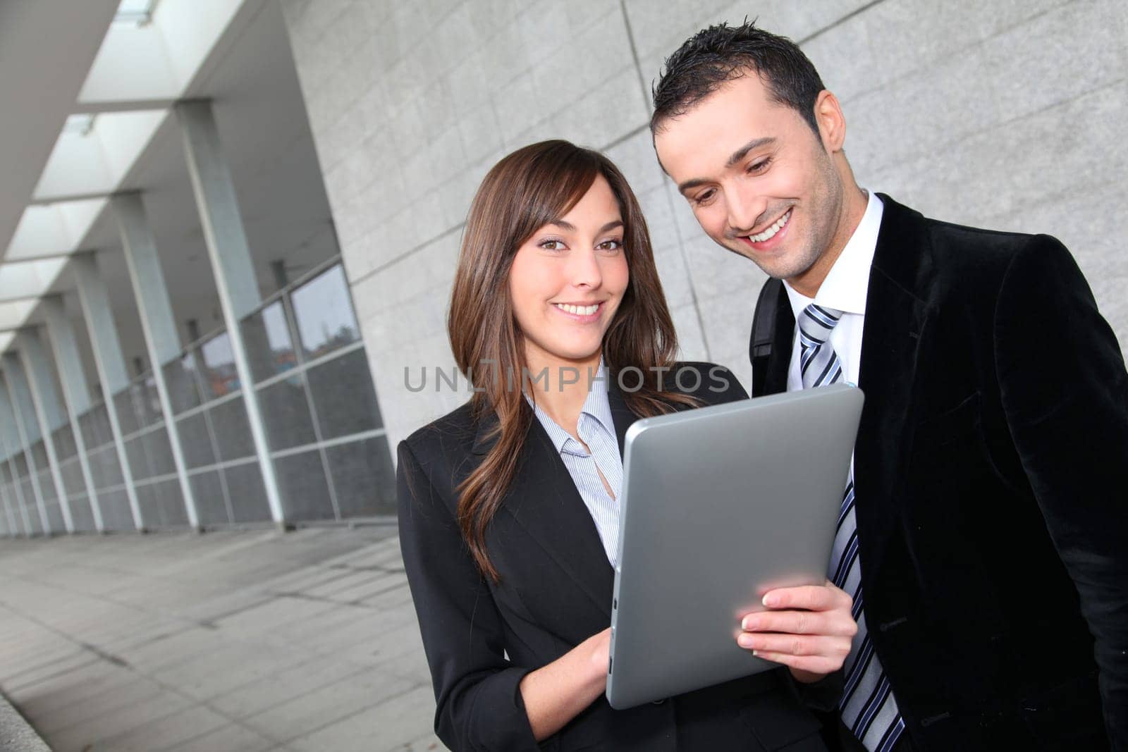 Business people meeting outside with electronic tablet