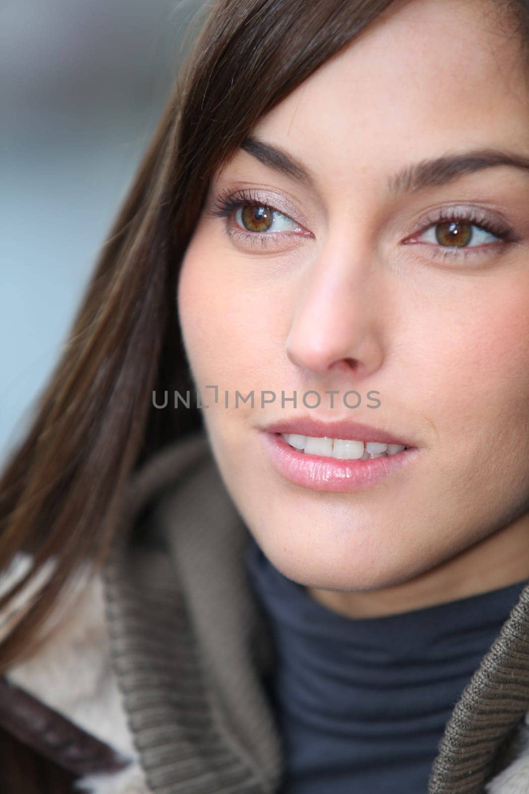 Closeup of beautiful woman with warm jacket in winter