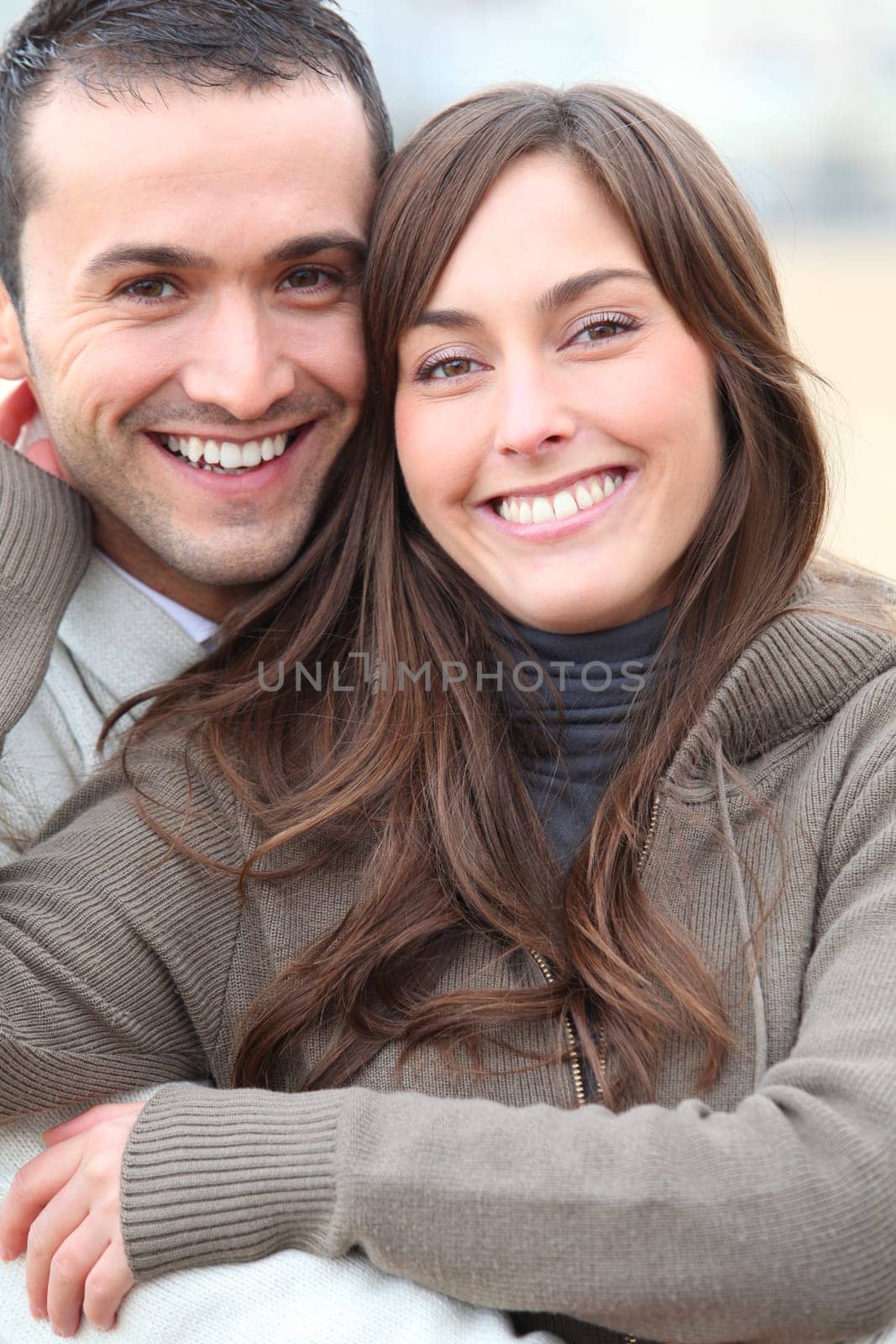 Young couple spending a week-end at the beach in winter