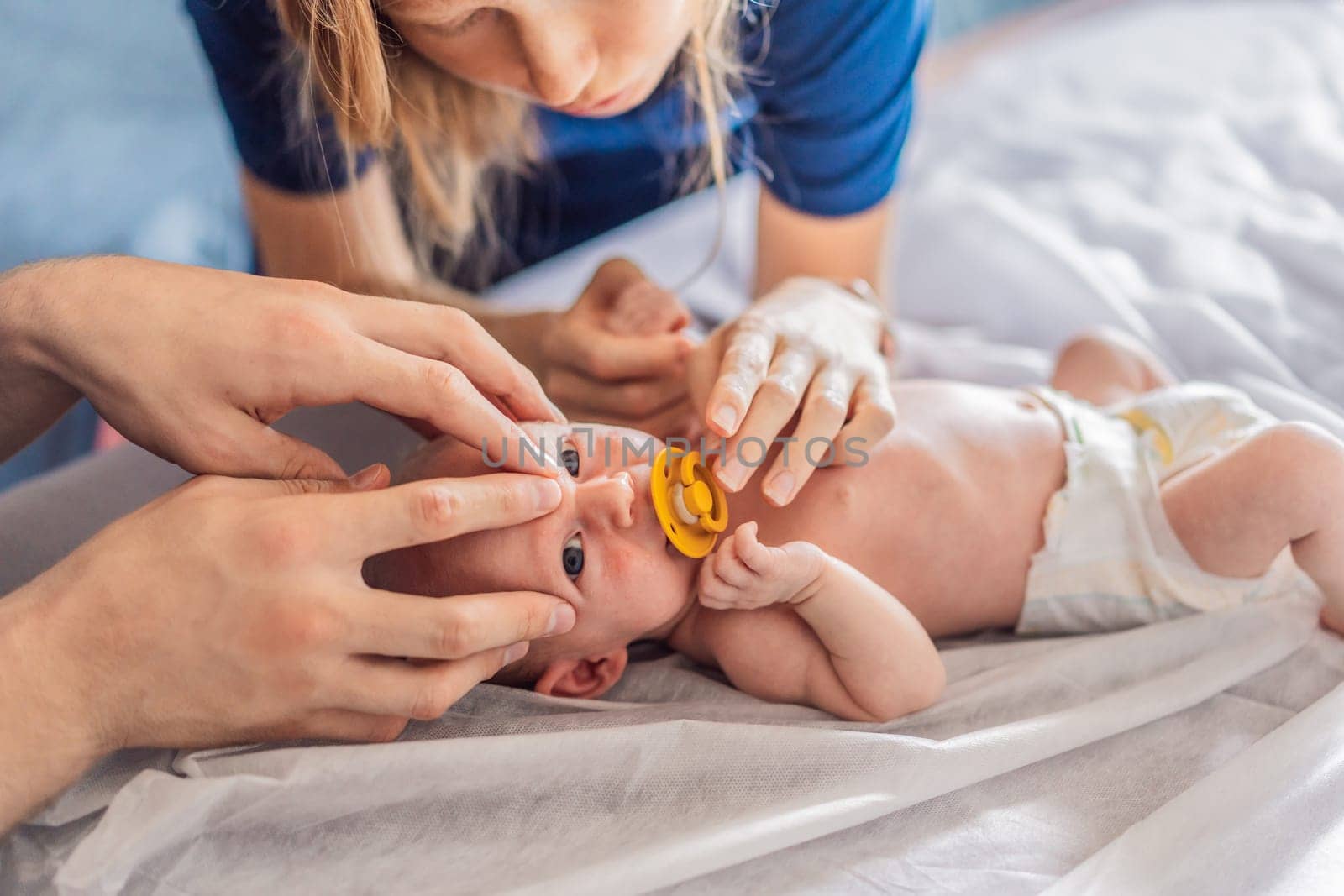 A newborn baby receives gentle osteopathic care, lying calmly while the specialist carefully examines and adjusts the infant. A moment of professional pediatric care, early development, and holistic well-being, symbolizing health and nurturing touch.