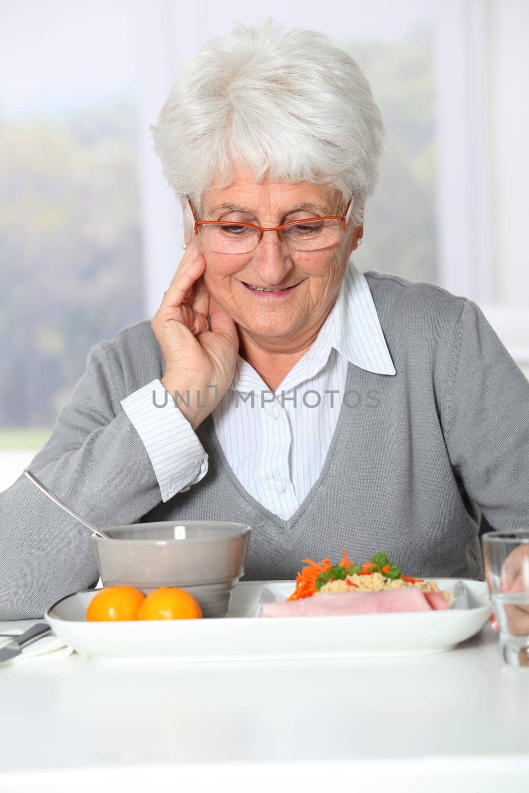 Old woman in nursing home ready to have dinner