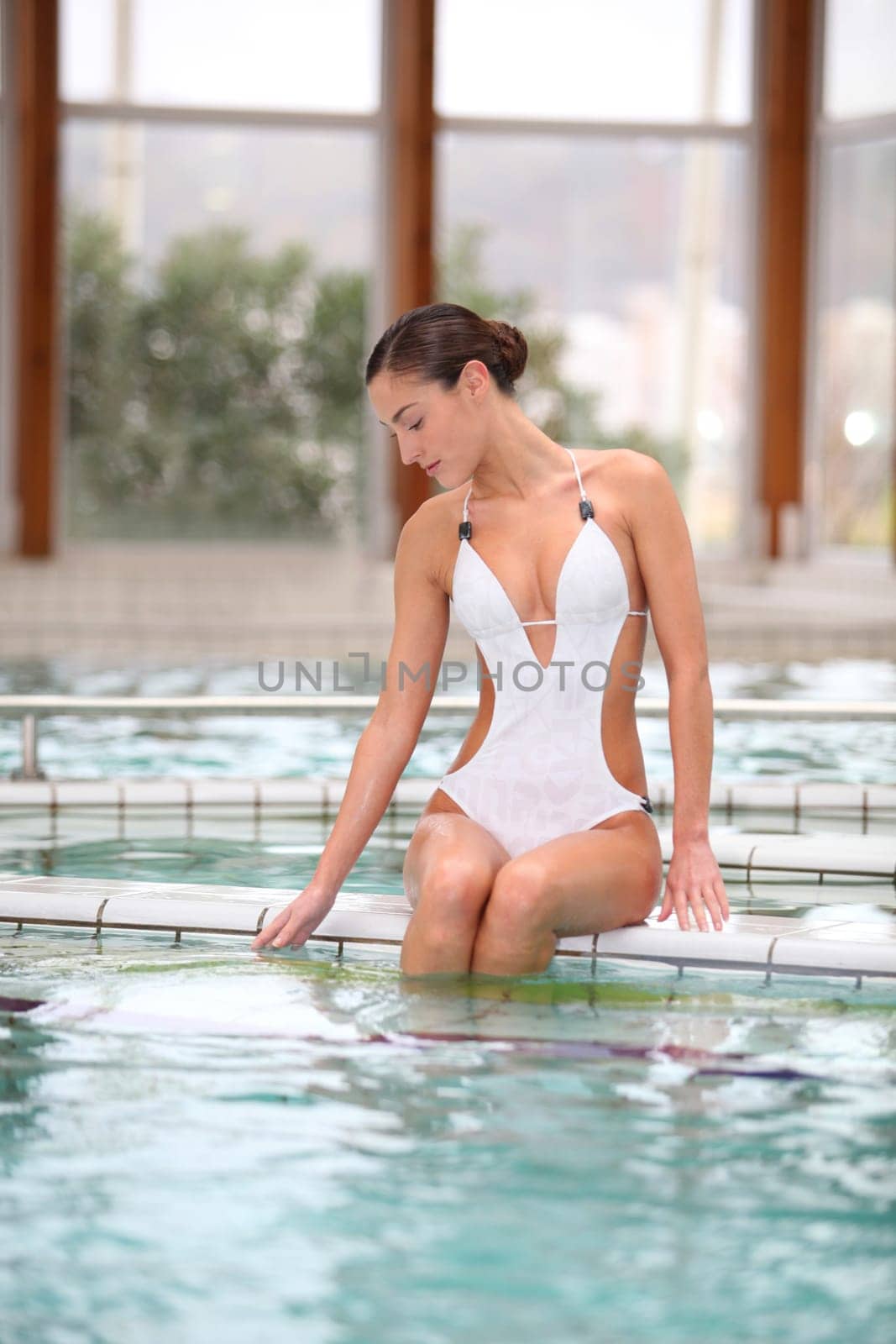Beautiful woman laying by a thalassotherapy pool