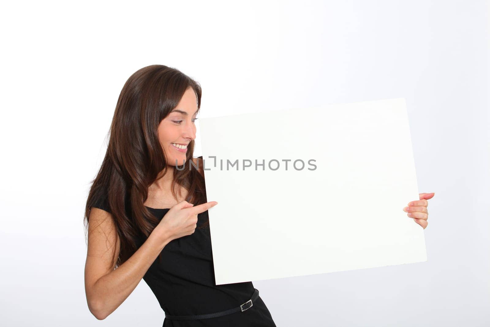 Woman in black dress showing message on white board