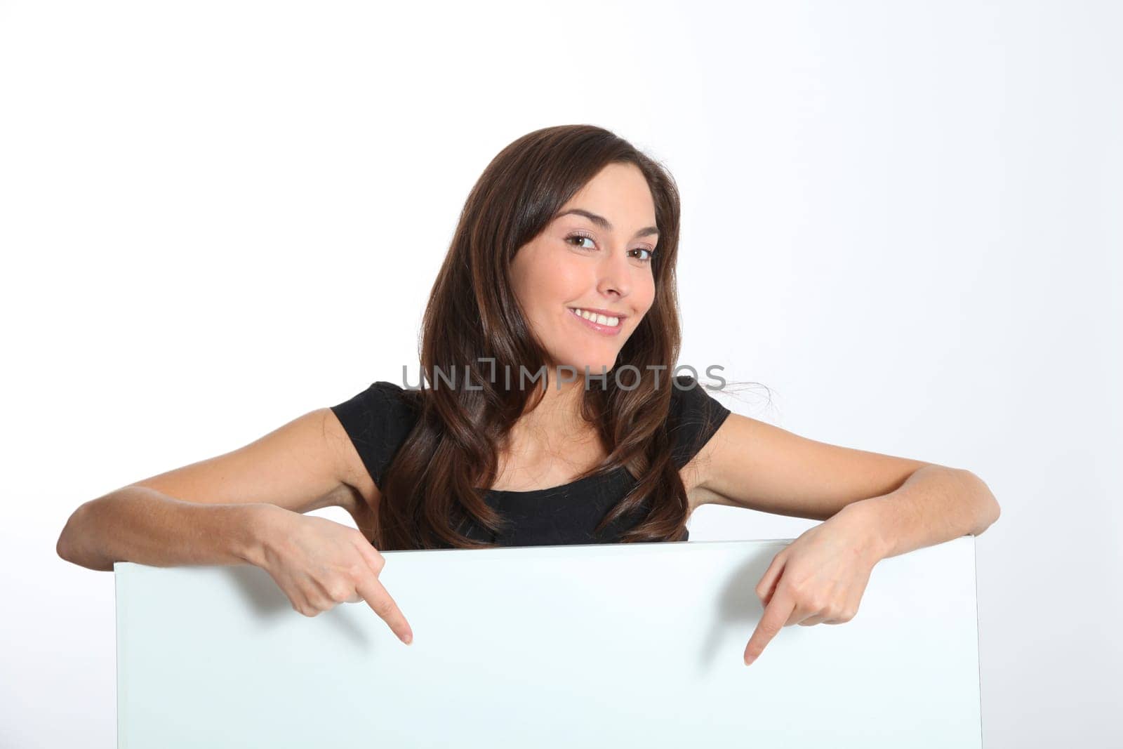 Woman in black dress showing message on white board