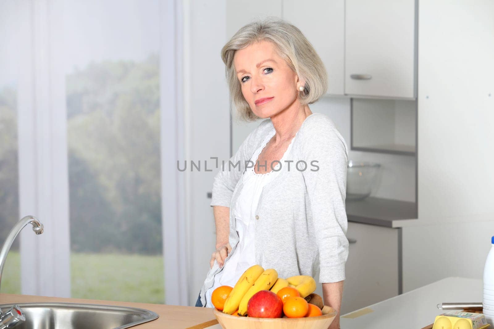 Senior woman standing in kitchen