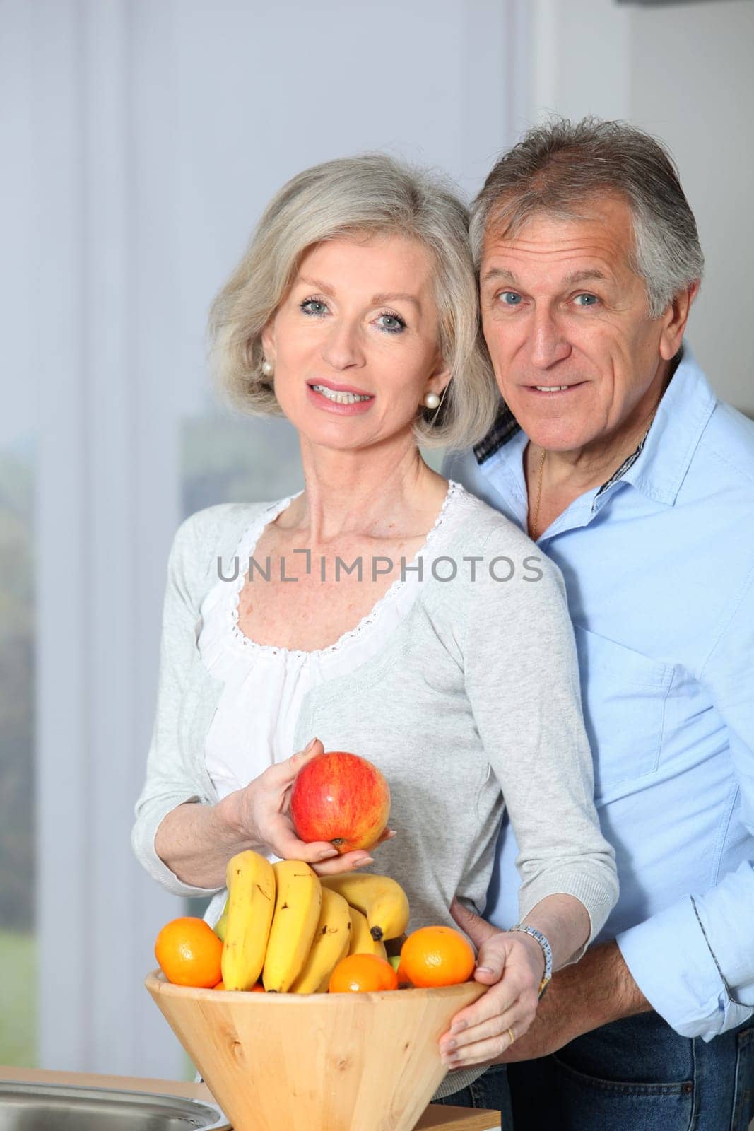 Closeup of happy senior couple in kitchen