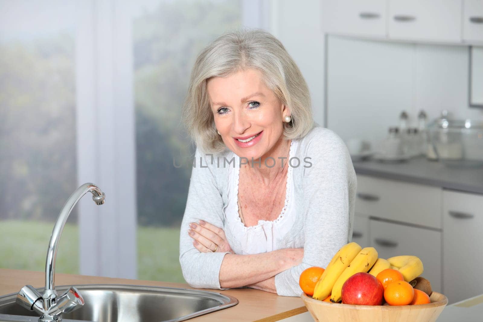 Senior woman standing in kitchen
