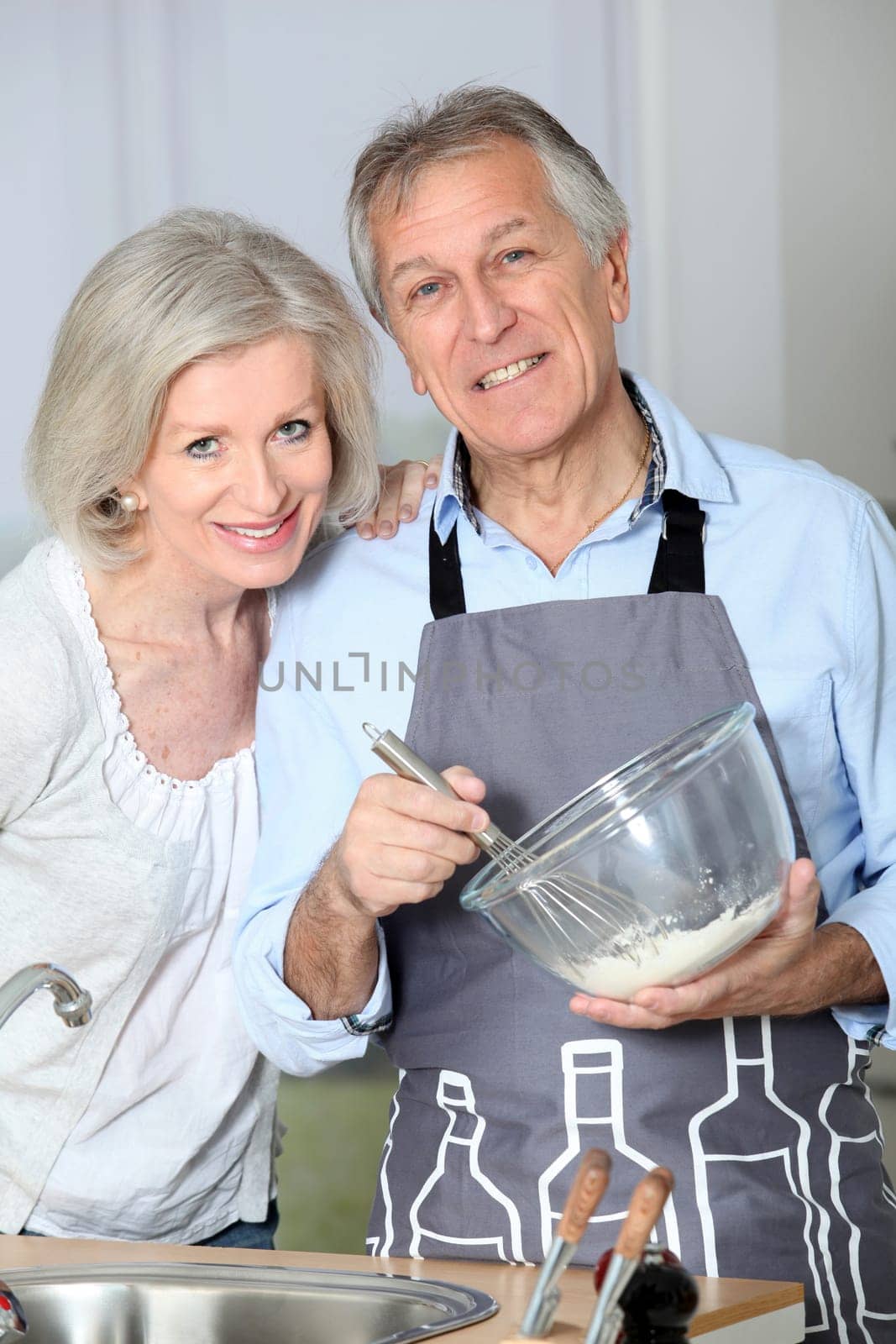 Happy senior couple baking together