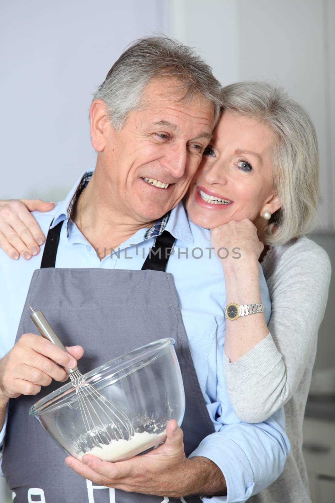 Happy senior couple baking together