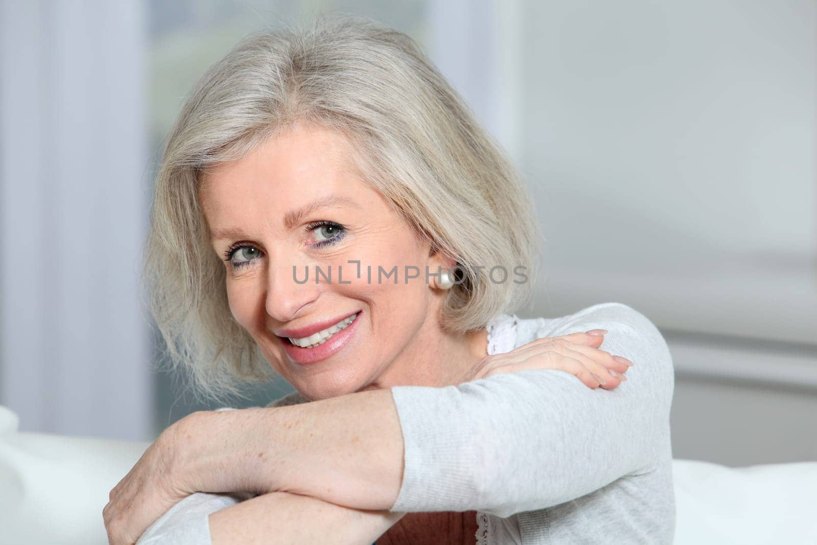 Closeup of smiling senior woman relaxing at home