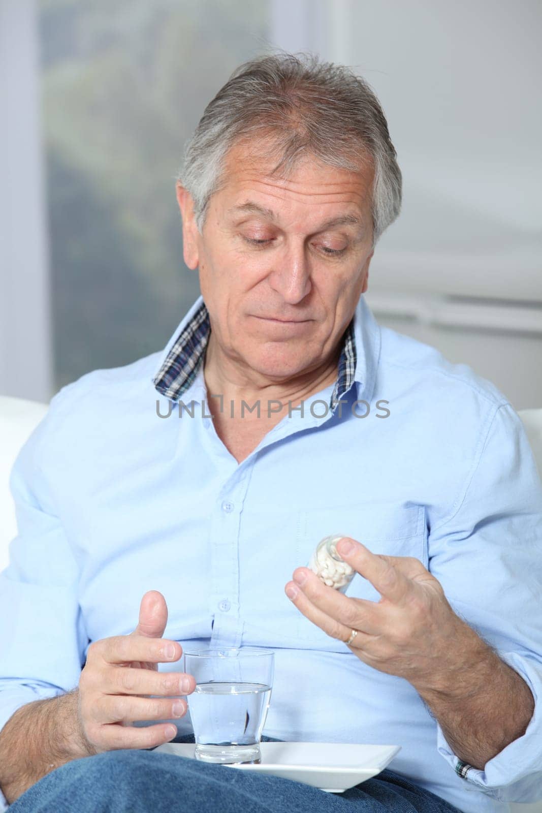 Senior man taking medicine