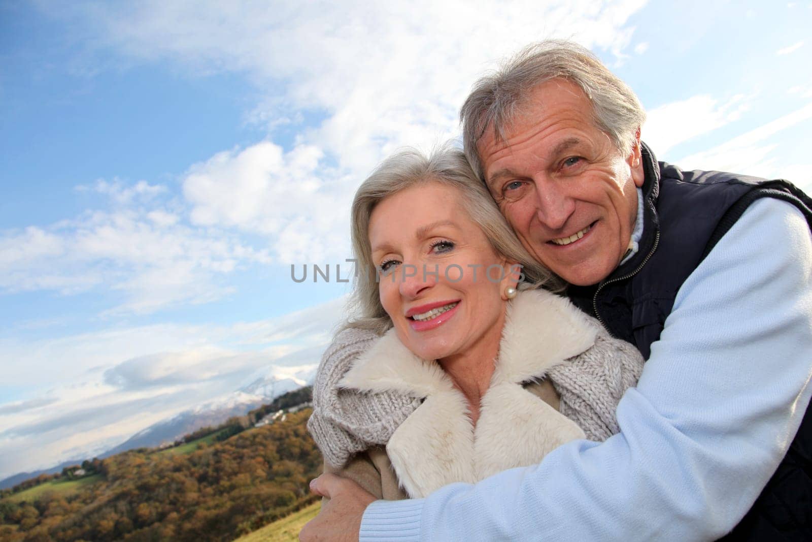 Portrait of happy senior couple in countryside