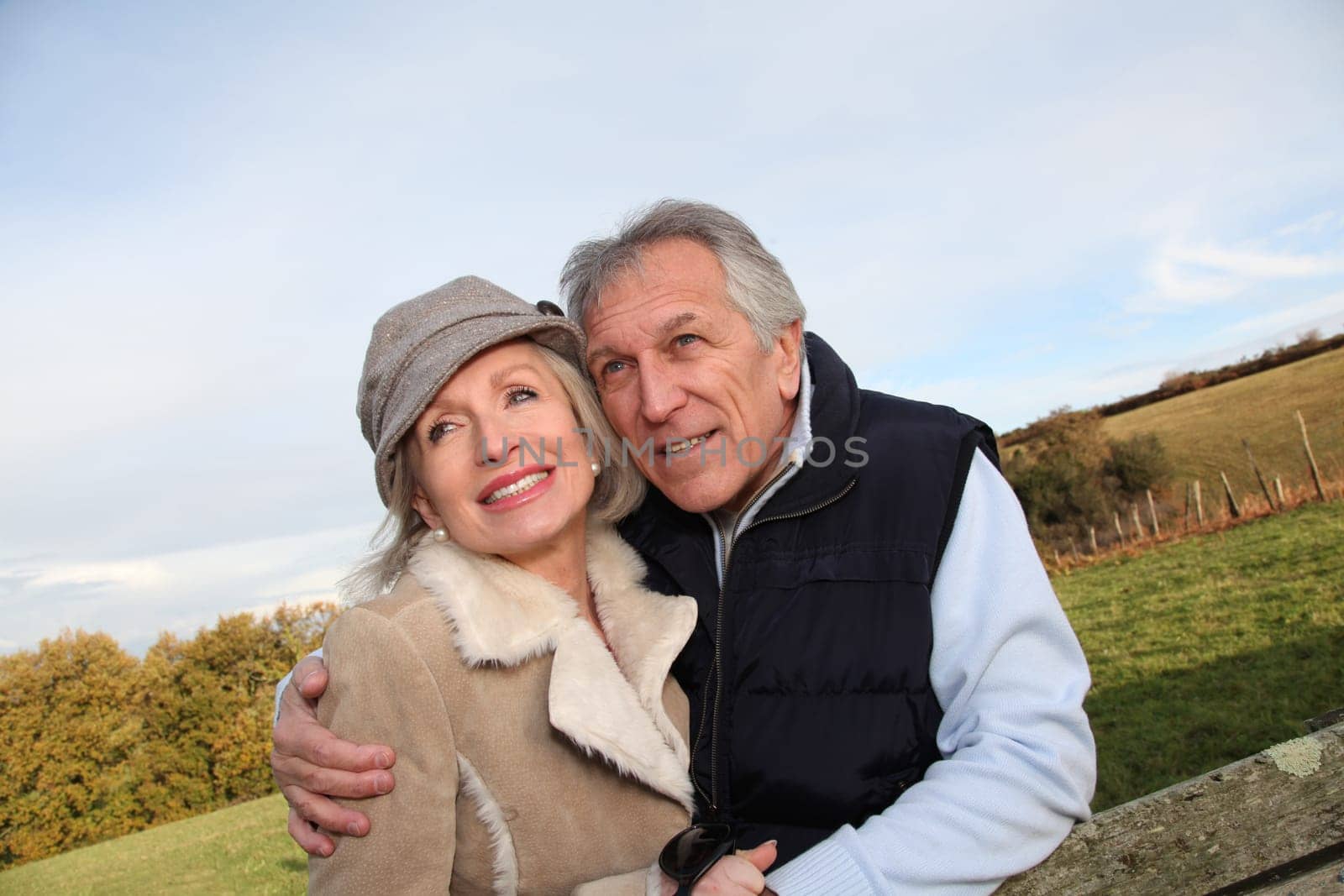 Happy senior couple embracing each other in countryside