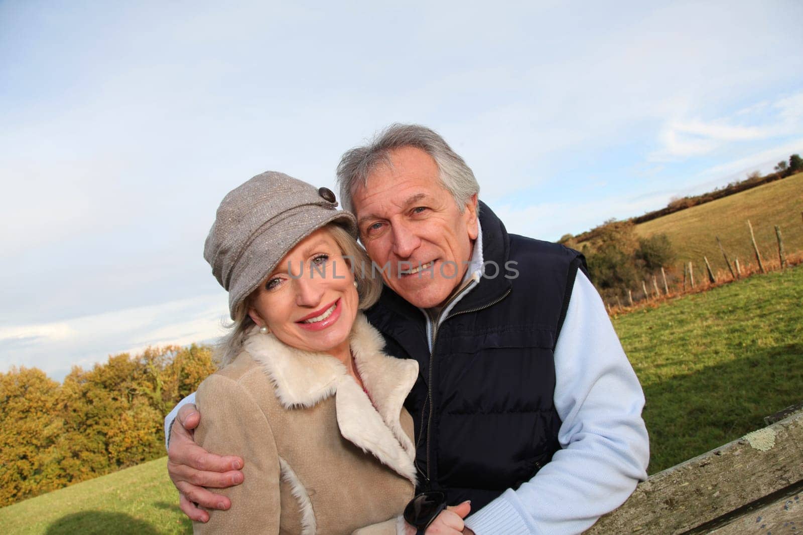 Happy senior couple embracing each other in countryside