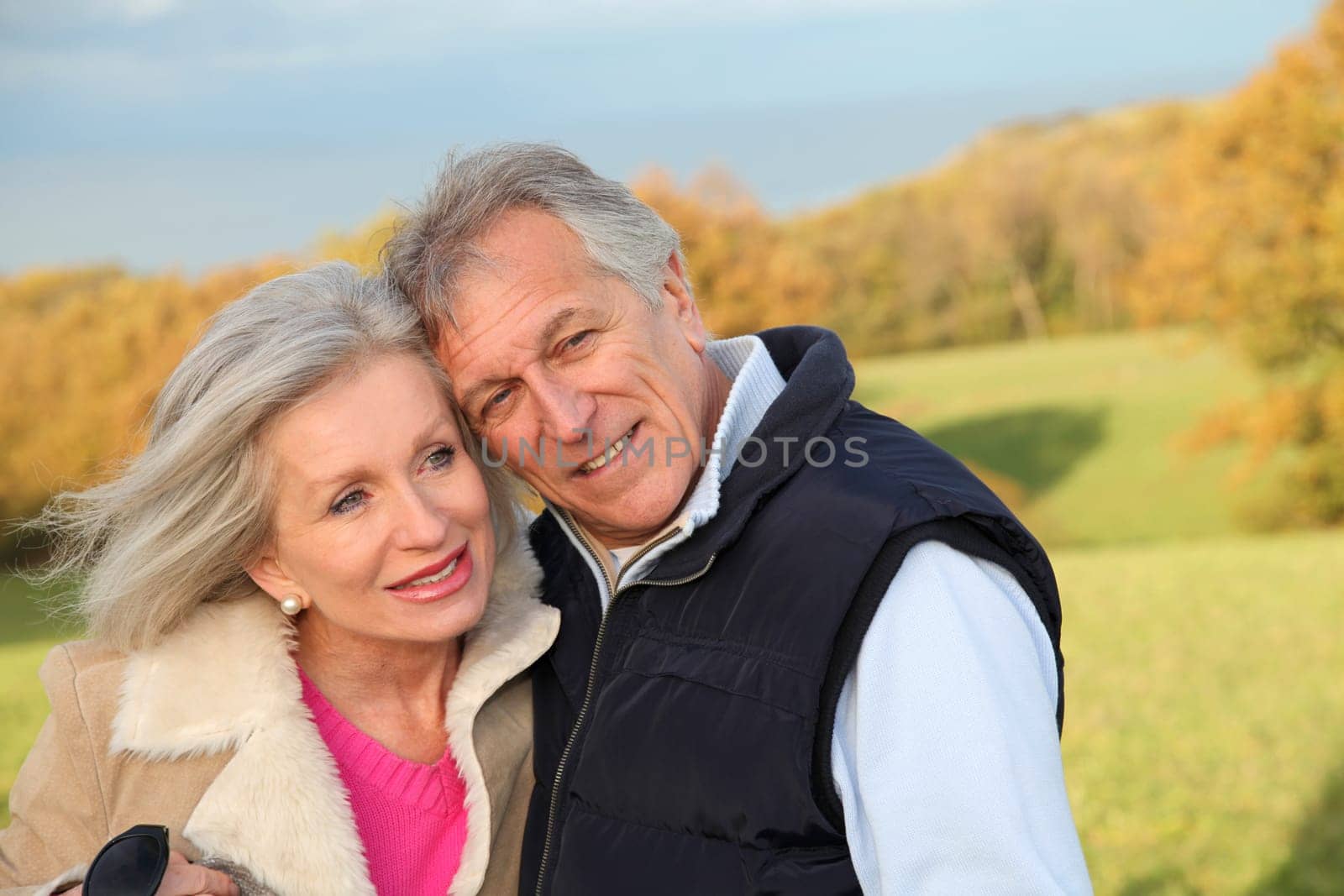 Happy senior couple embracing each other in countryside