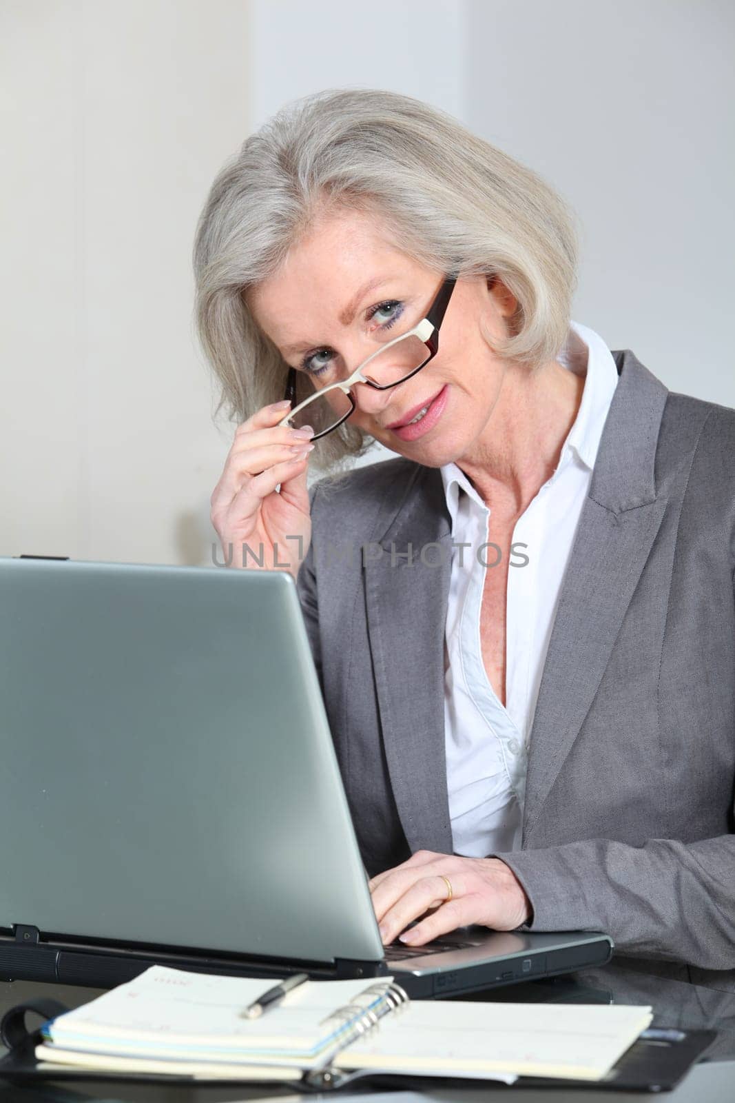 Senior businesswoman with eyeglasses working in the office