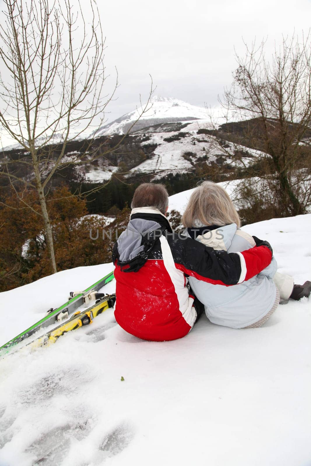 Senior couple at ski resortlooking at the mountain