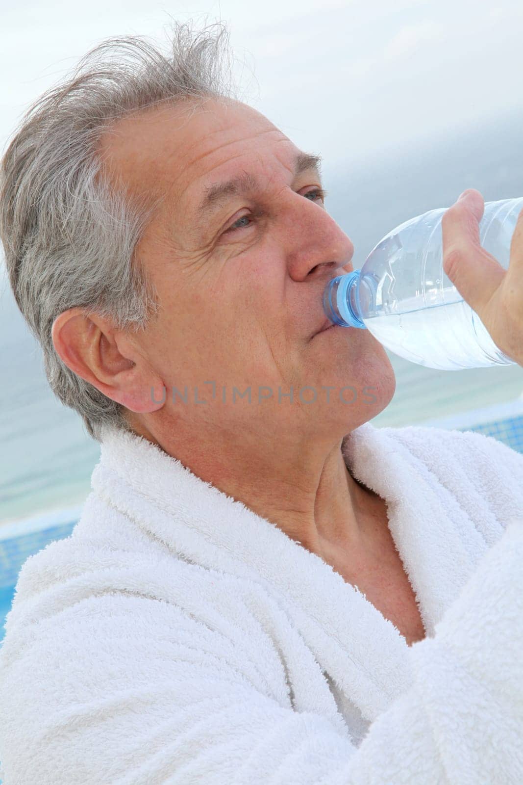 Senior man dinking water from bottle