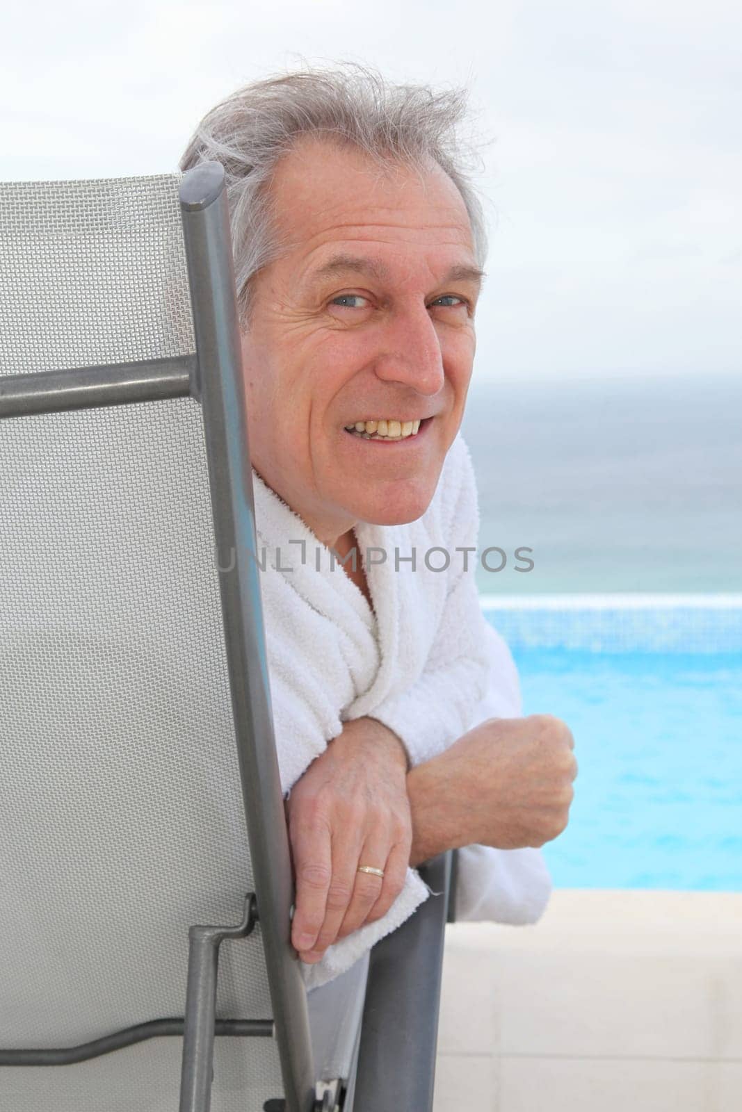 Senior couple relaxing in long chairs