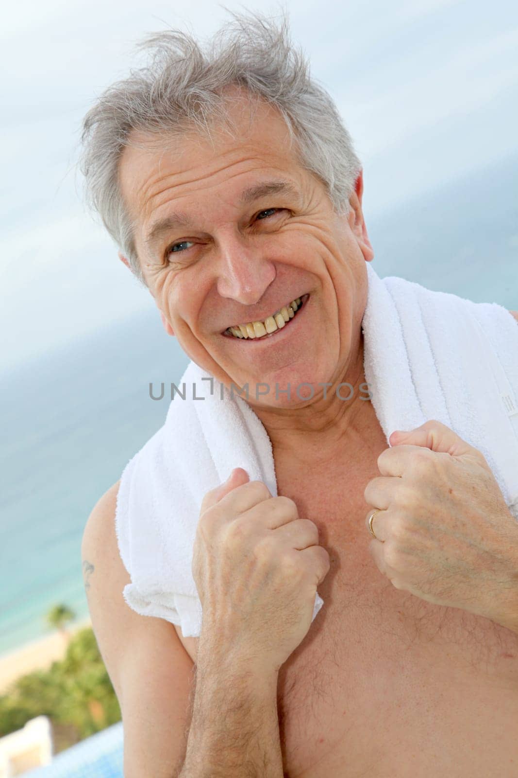 Portrait of senior man with towel aroung his neck