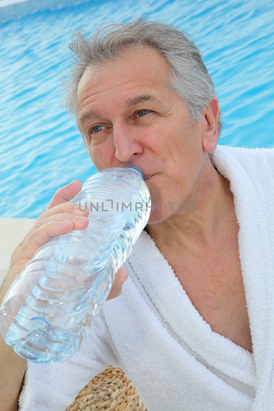Senior man dinking water from bottle