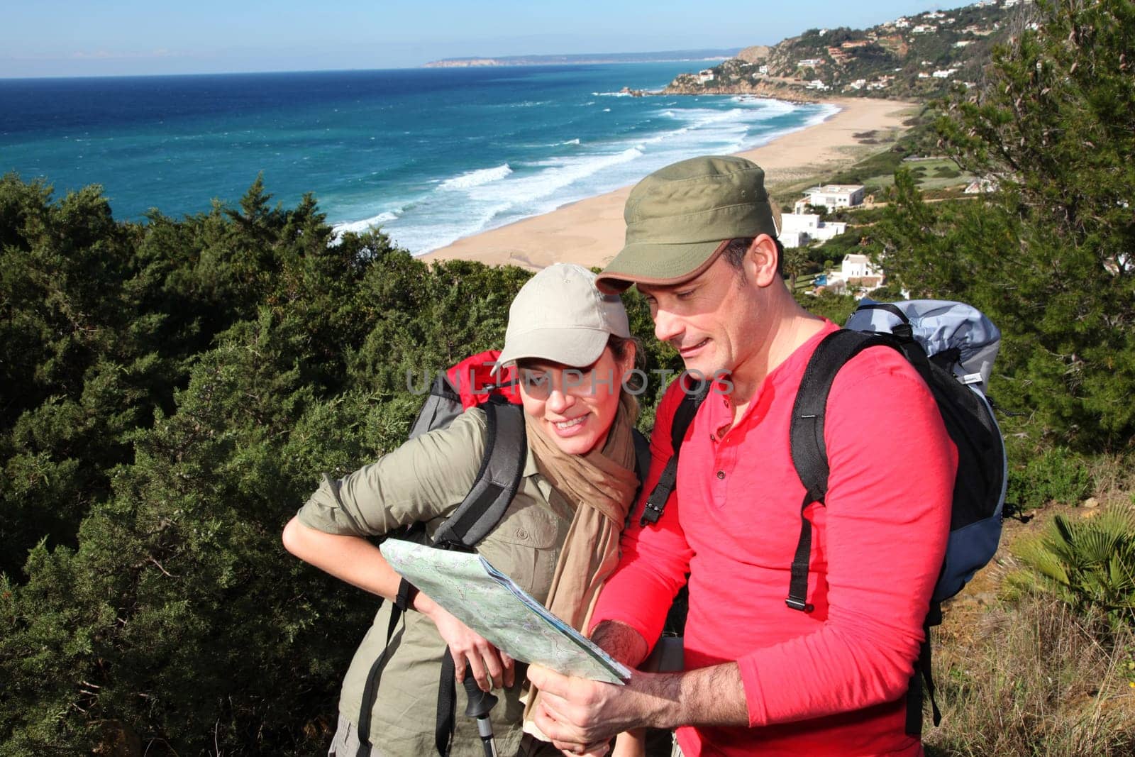 Couple looking at map on a hiking day