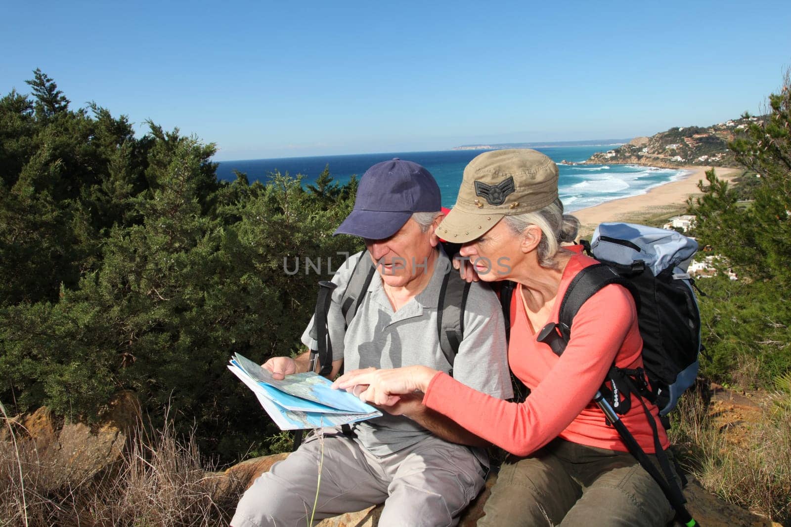 Senior couple looking at map on a rambling day